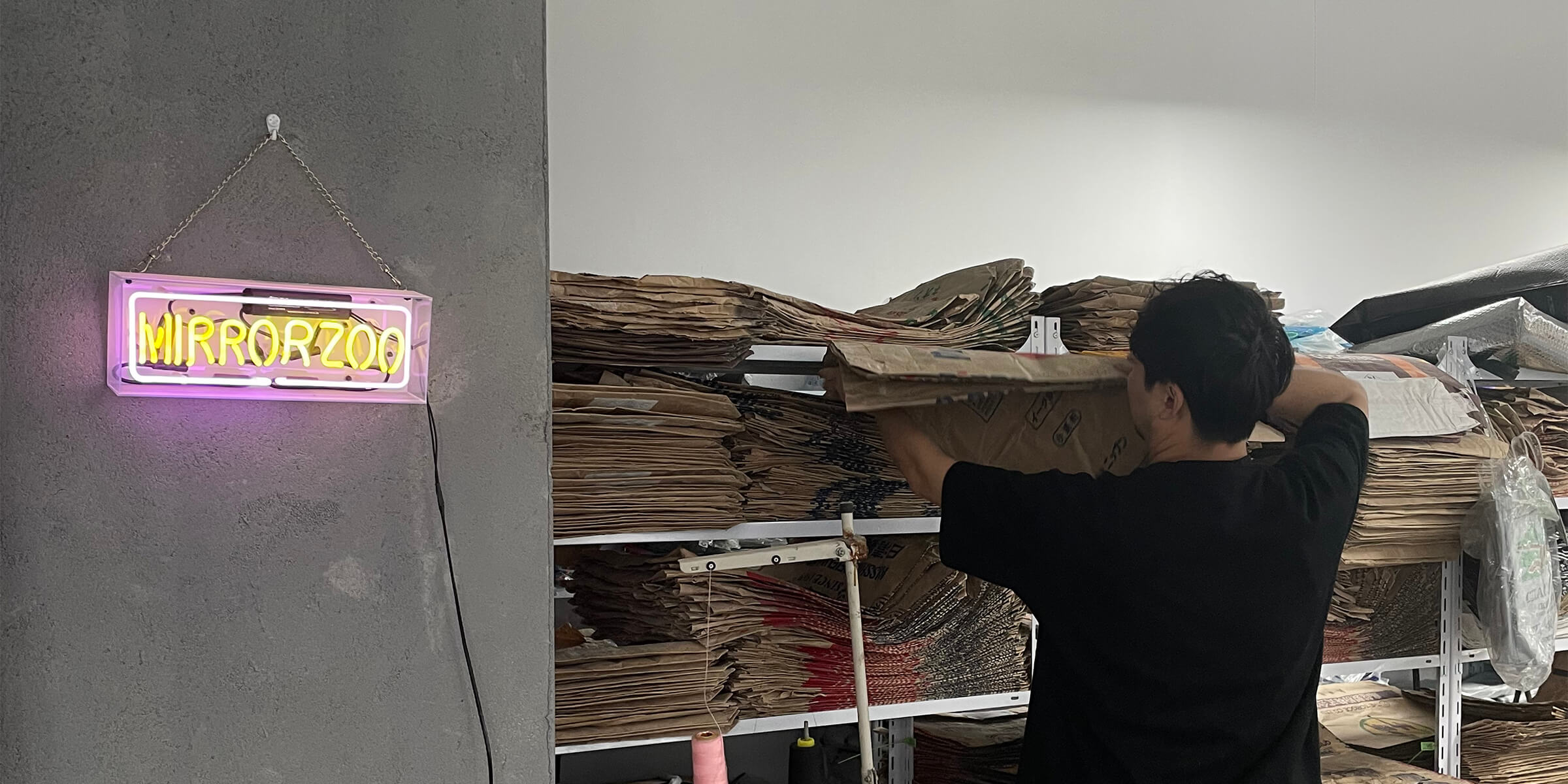 Mirror Zoo Warehouse Shelves Filled with Recycled Flour Sacks